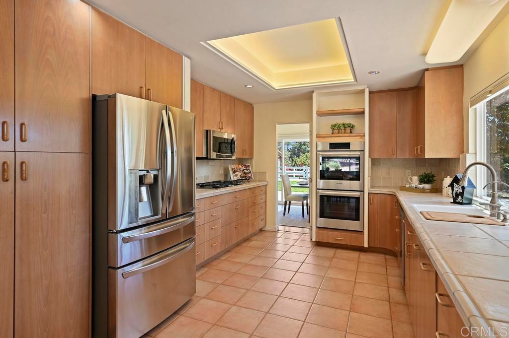 546 Rancho Santa Fe Road Encinitas, CA 92024 - Photo 10 of 48 a kitchen with stainless steel appliances granite countertop a refrigerator sink and stove
