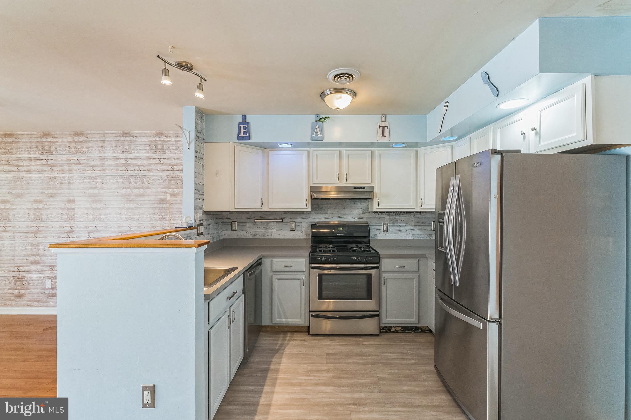 3566 Edgemont Street Philadelphia, PA 19134 - Photo 6 of 25 a kitchen with stainless steel appliances a refrigerator sink and cabinets