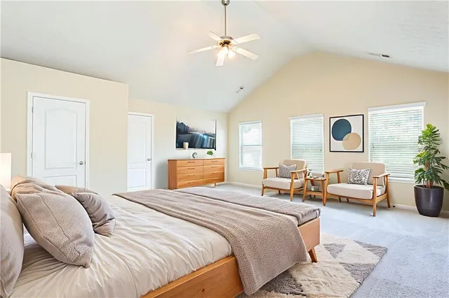 a bedroom with a bed couch and window