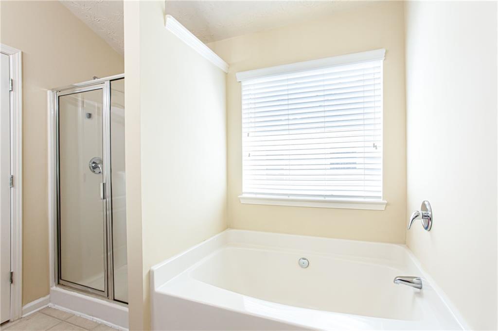 4628 McEver View Drive Sugar Hill, GA 30518 - Photo 20 of 30 a white bath tub sitting next to a window