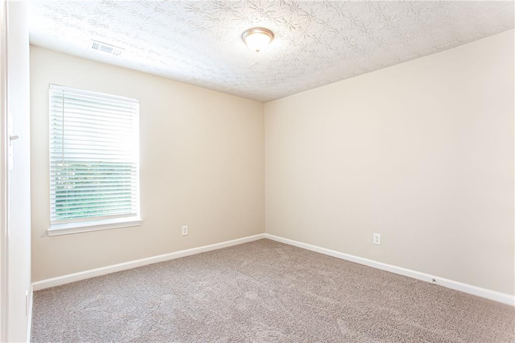 4628 McEver View Drive Sugar Hill, GA 30518 - Photo 21 of 30 an empty room with a window