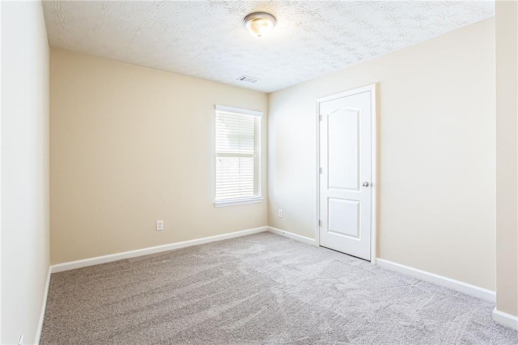 4628 McEver View Drive Sugar Hill, GA 30518 - Photo 23 of 30 an empty room with windows and closet