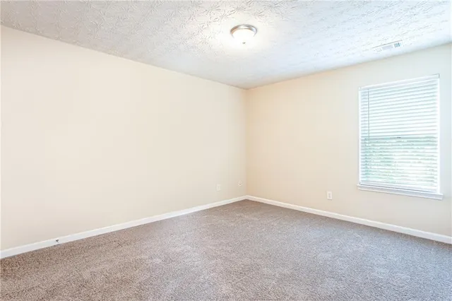 an empty room with a empty space and a window