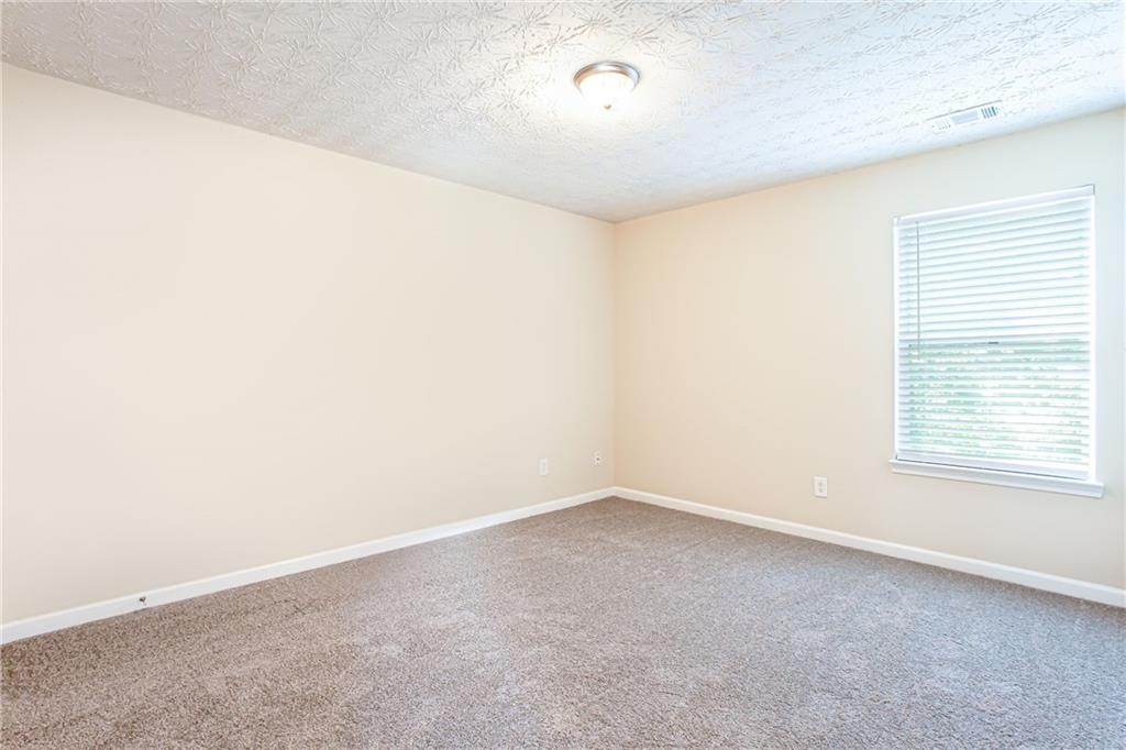 4628 McEver View Drive Sugar Hill, GA 30518 - Photo 26 of 30 an empty room with a empty space and a window