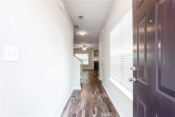 a view of hallway with wooden floor