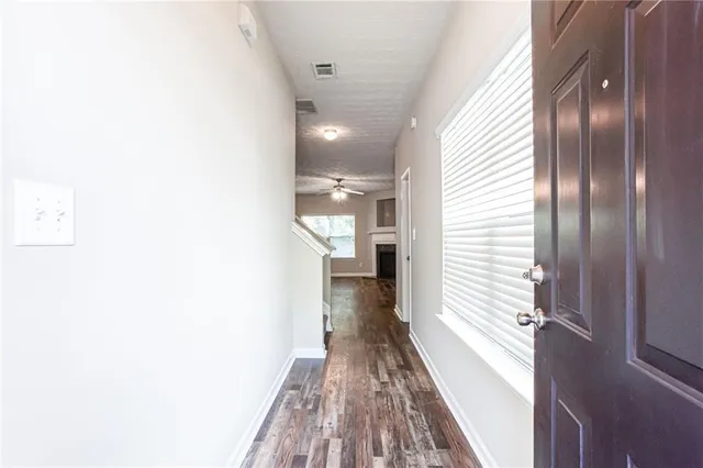 a view of hallway with wooden floor