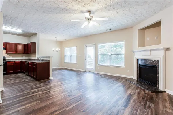 a large kitchen with stainless steel appliances a stove top oven and a fireplace