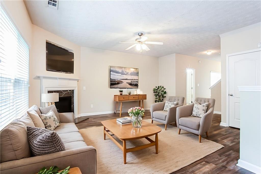 4628 McEver View Drive Sugar Hill, GA 30518 - Photo 6 of 30 a living room with furniture fireplace and a flat screen tv