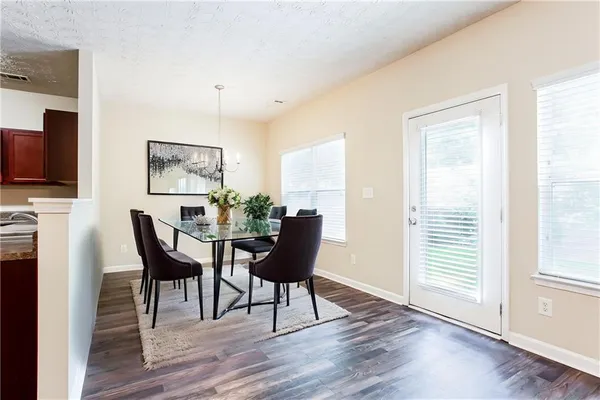 a view of a dining room with furniture and wooden floor
