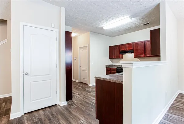 a kitchen with stainless steel appliances granite countertop a refrigerator and a stove top oven