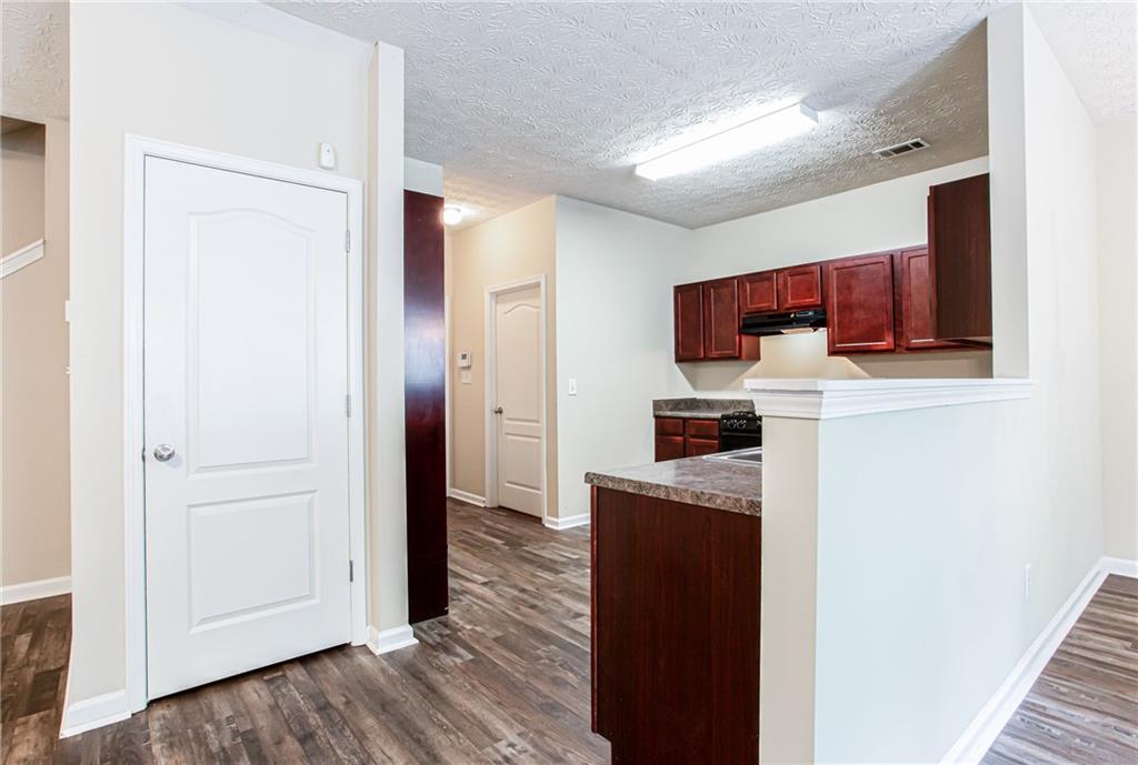 4628 McEver View Drive Sugar Hill, GA 30518 - Photo 9 of 30 a kitchen with stainless steel appliances granite countertop a refrigerator and a stove top oven