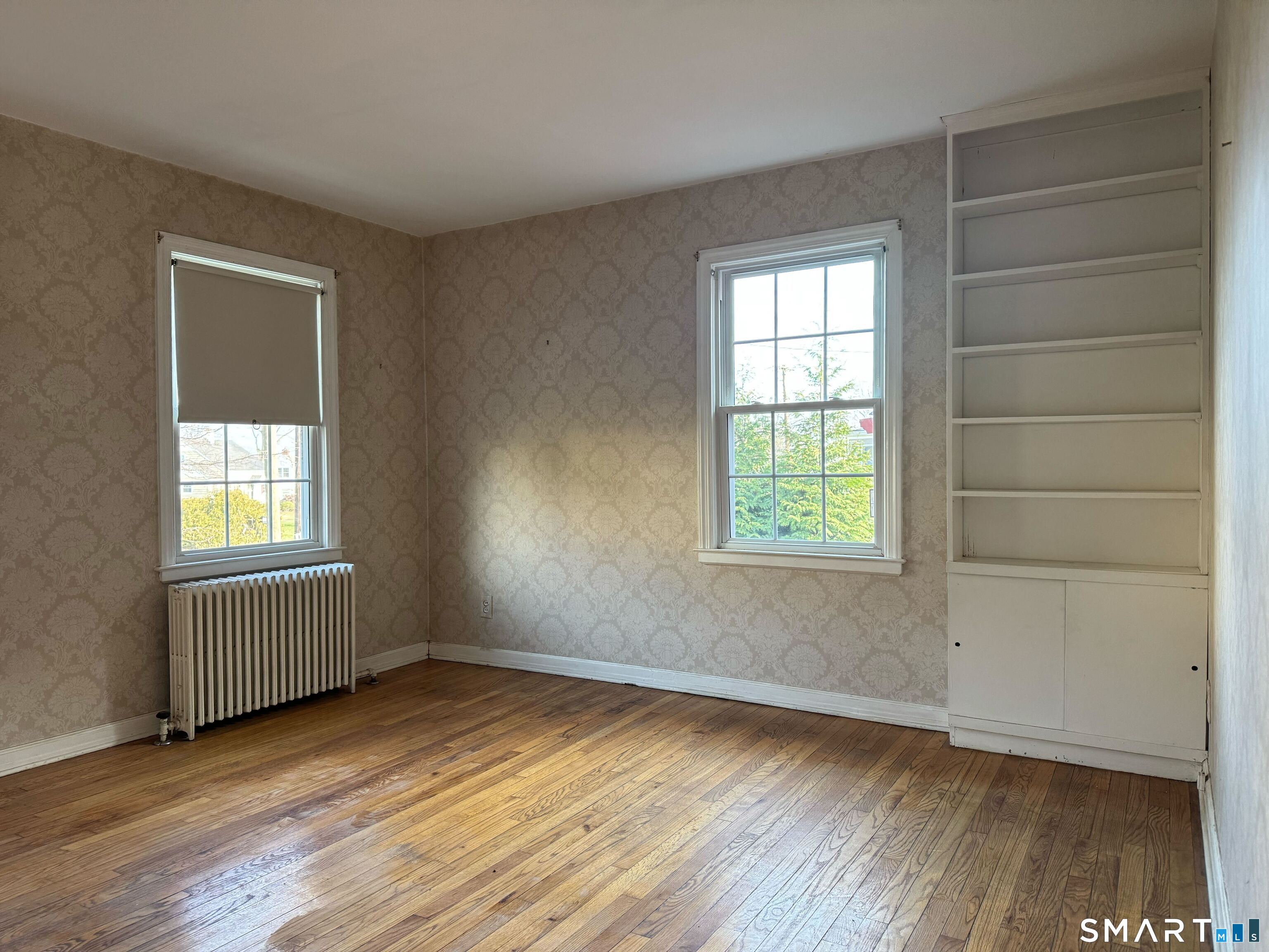 15 Townline Road Hamden, CT 06517 - Photo 11 of 16 an empty room with wooden floor and windows