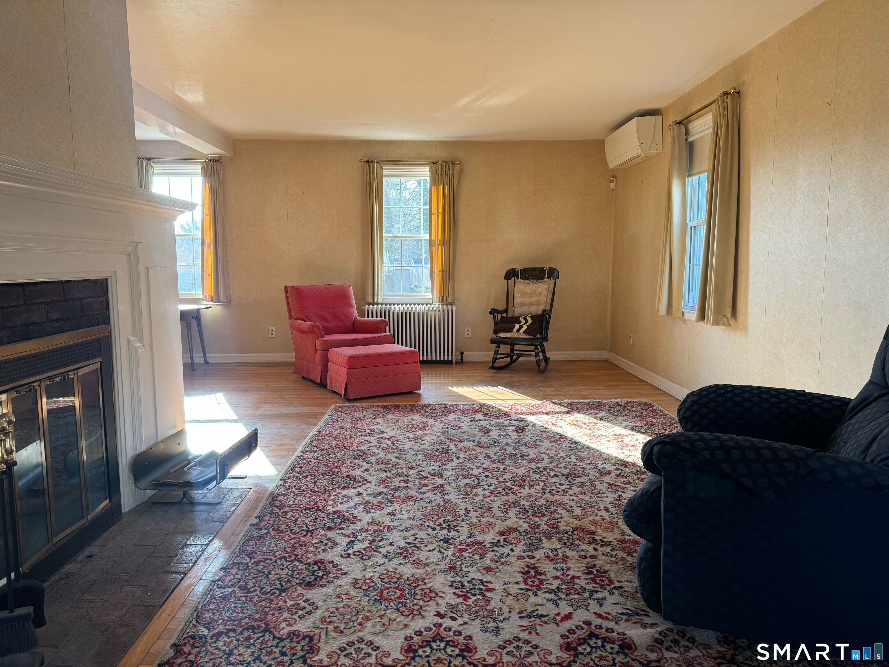 15 Townline Road Hamden, CT 06517 - Photo 2 of 16 a living room with furniture windows and a fireplace