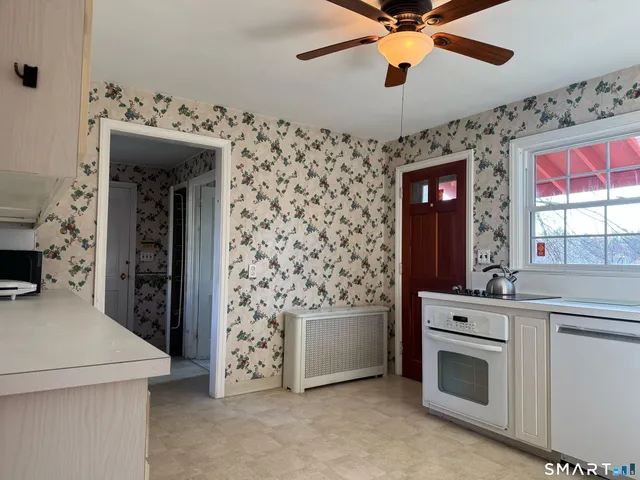 a kitchen with stainless steel appliances kitchen island granite countertop a stove and a sink