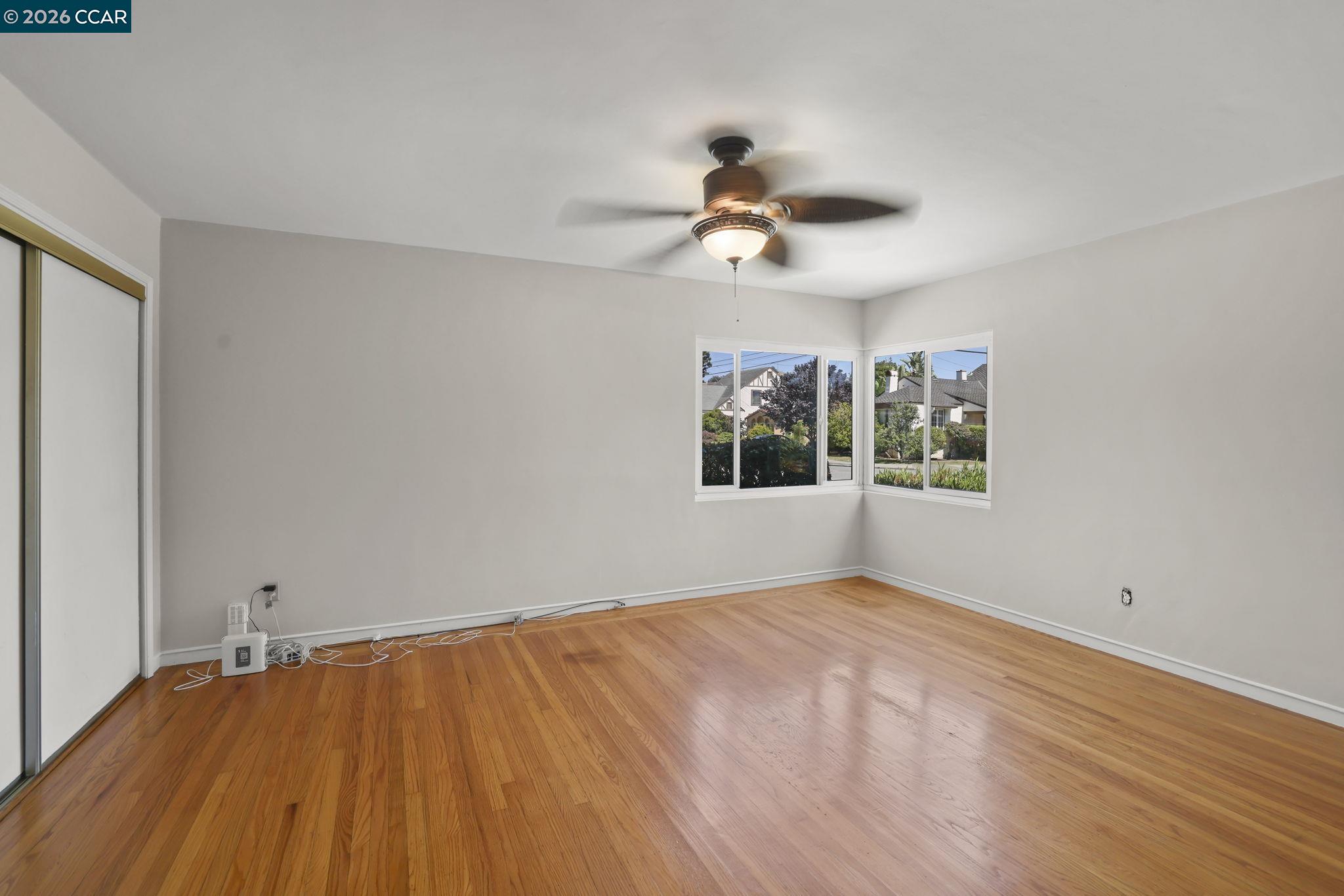 1051 San Rafael Street San Leandro, CA 94577 - Photo 17 of 26 a view of empty room with wooden floor and fan
