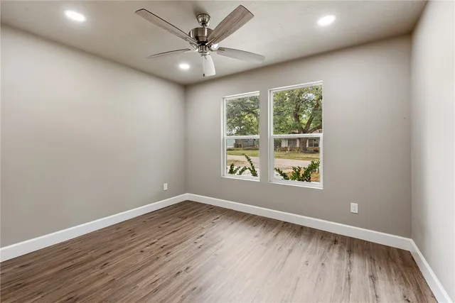 a bathroom with a granite countertop sink a toilet and shower