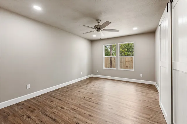 a bathroom with a granite countertop sink a toilet and a mirror