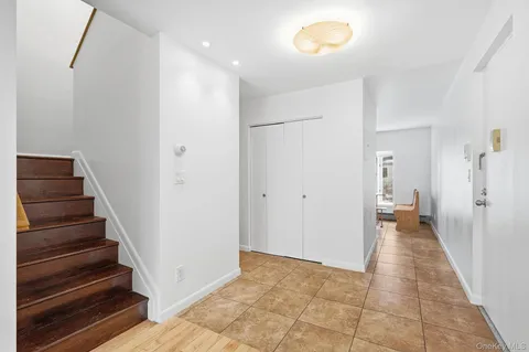 a view of a room with wooden floor and white walls