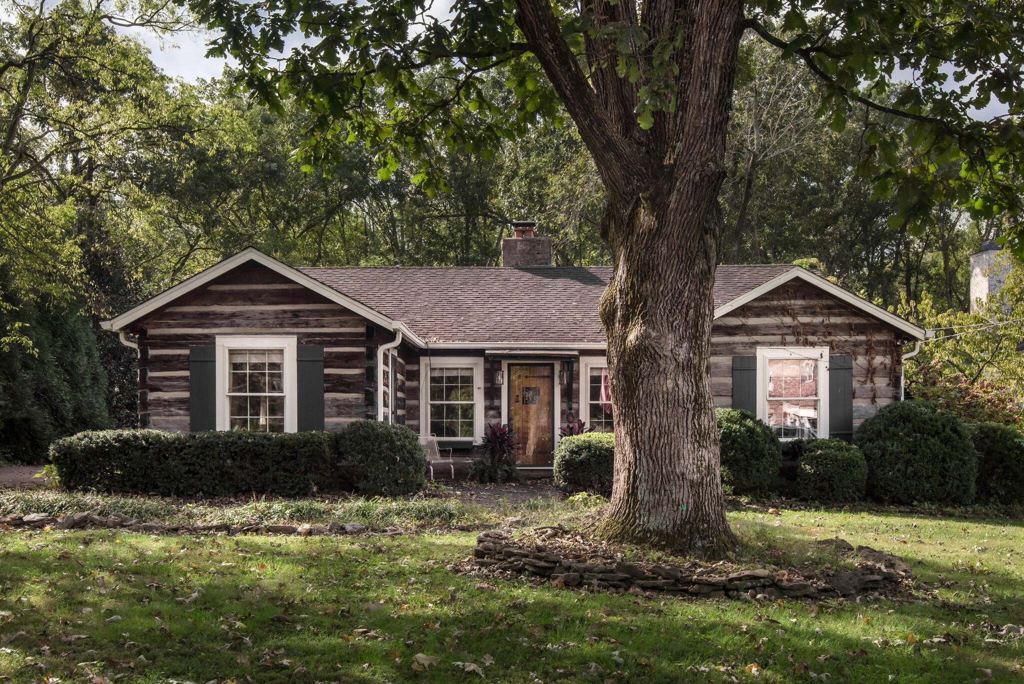 a front view of house with yard and trees around