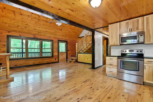 a view of a kitchen with stainless steel appliances granite countertop a stove and a refrigerator