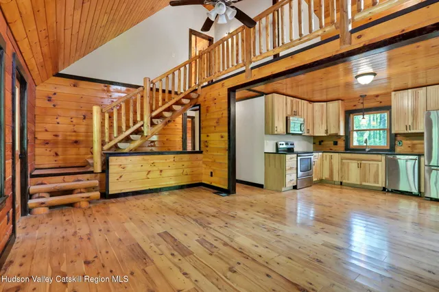 a view of a kitchen with furniture and wooden floor