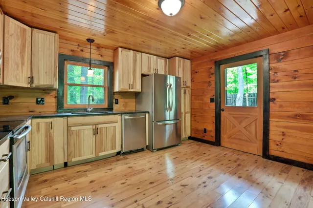 a kitchen with window and cabinets