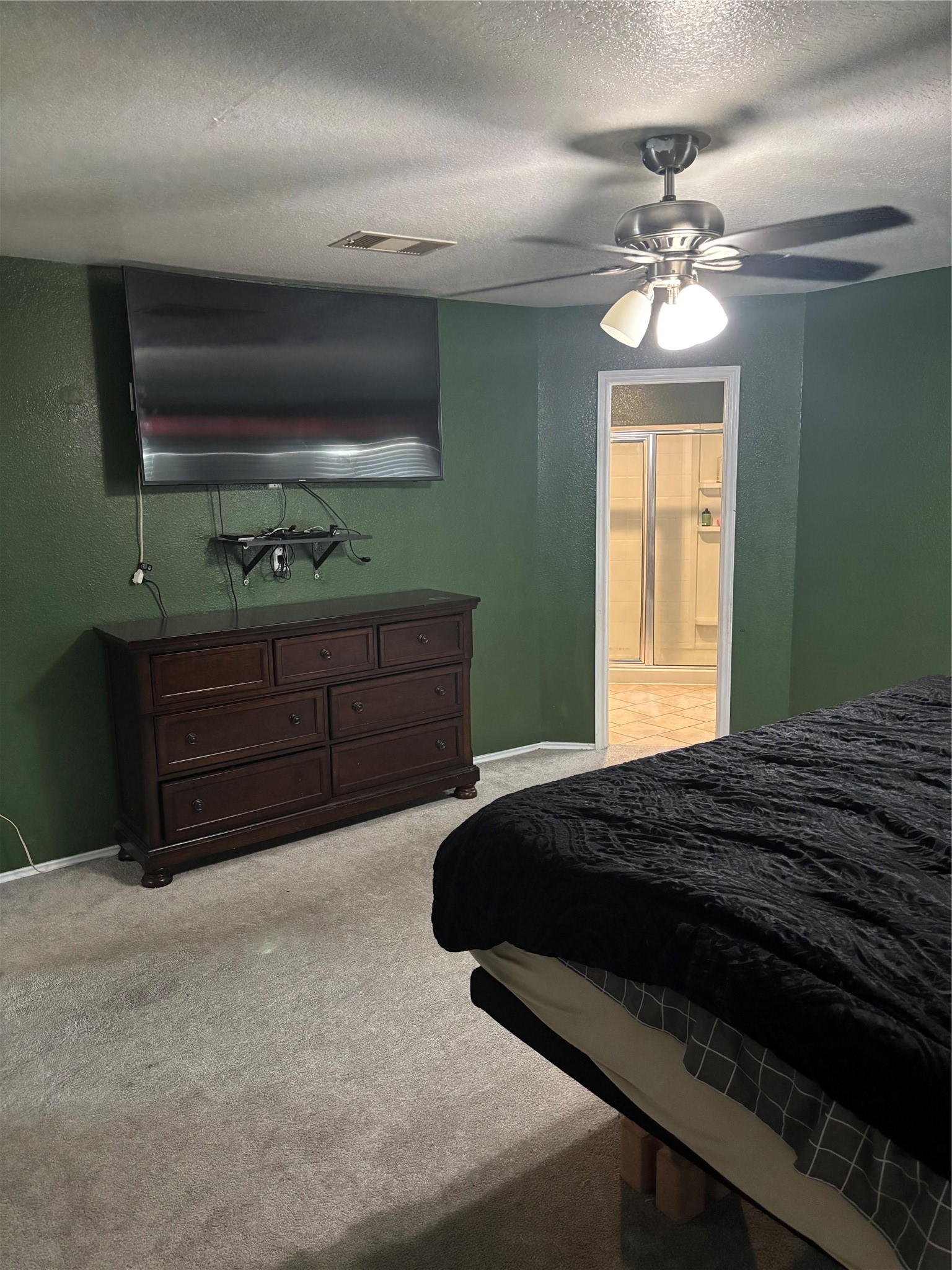 23502 Dukes Run Drive Spring, TX 77373 - Photo 5 of 6 a bedroom with a bed and a chandelier