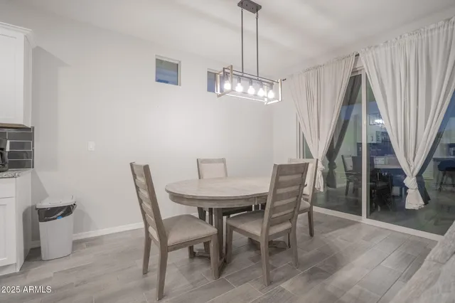 a view of a dining room with furniture wooden floor and chandelier