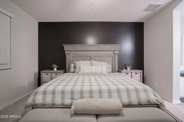a bedroom with a bed and a night stand