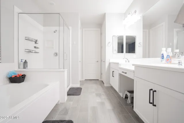a bathroom with a sink a tub and a mirror