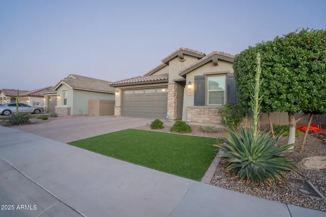 a front view of a house with a garden