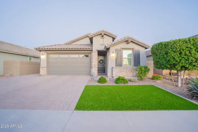a front view of a house with a yard and garage