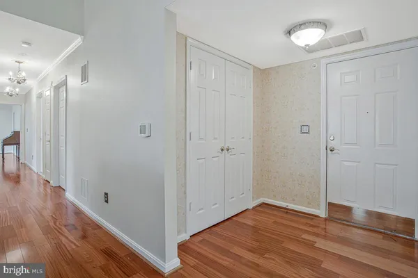a view of a hallway with wooden floor
