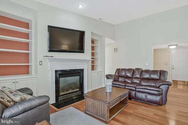 a living room with furniture flat screen tv and a fireplace