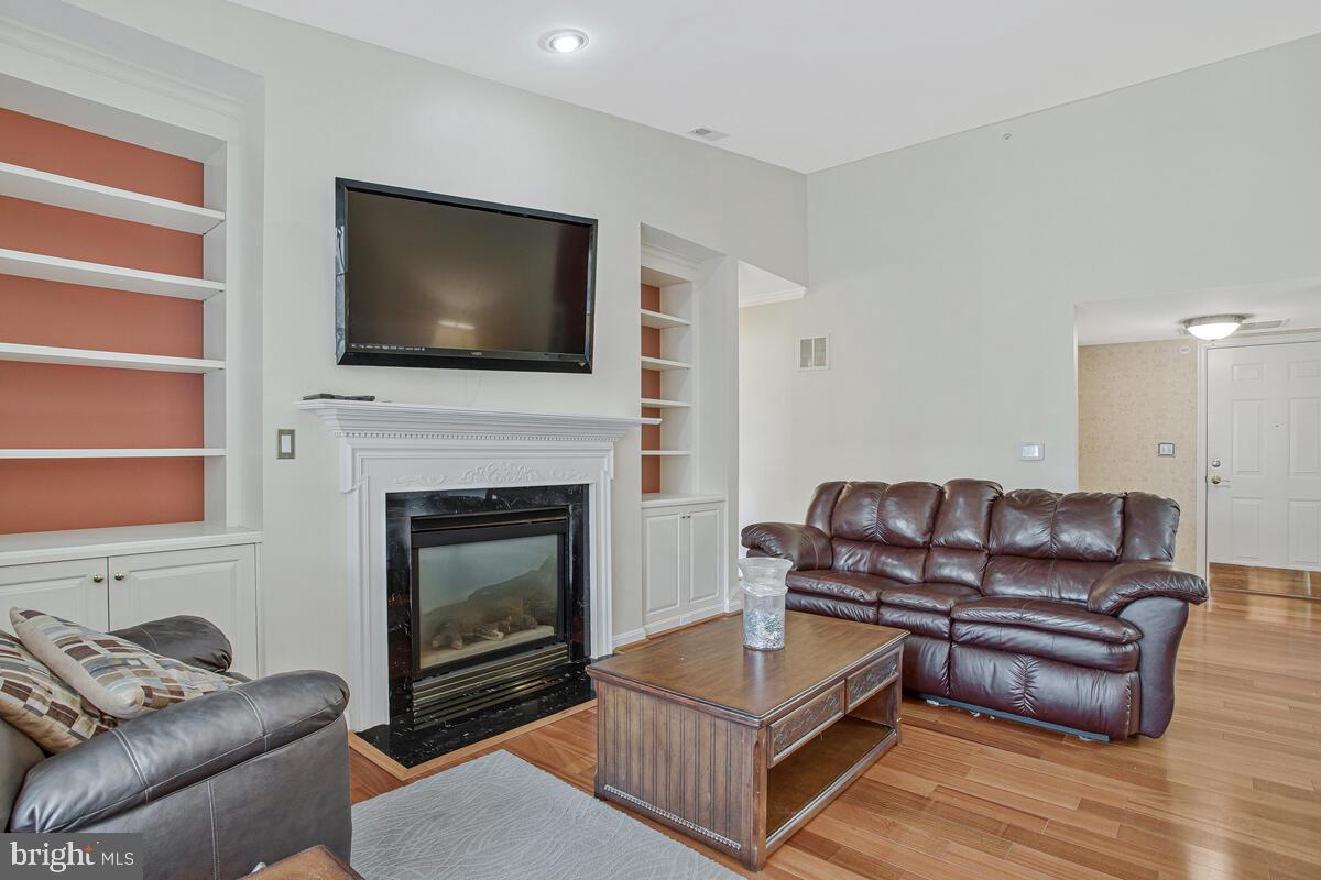 12300 Rosslare Ridge Road, Unit 508 Lutherville-Timonium, MD 21093 - Photo 13 of 40 a living room with furniture flat screen tv and a fireplace