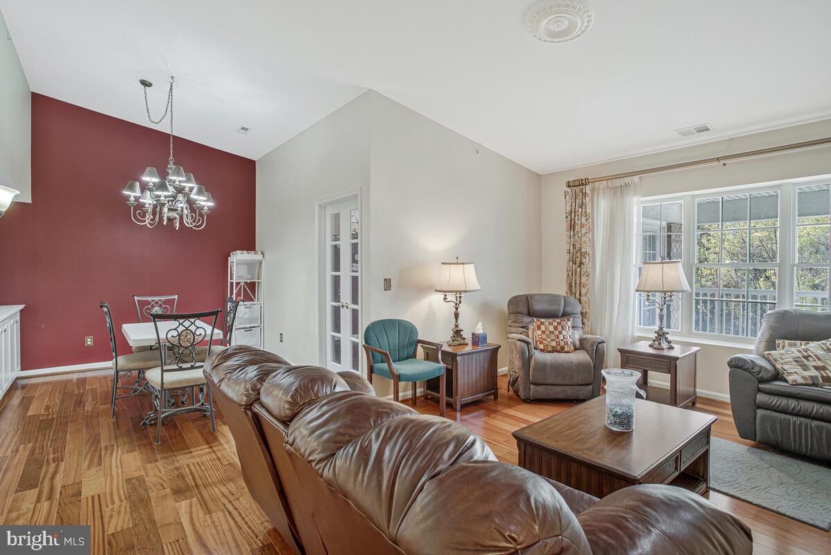 12300 Rosslare Ridge Road, Unit 508 Lutherville-Timonium, MD 21093 - Photo 14 of 40 a living room with furniture and wooden floor