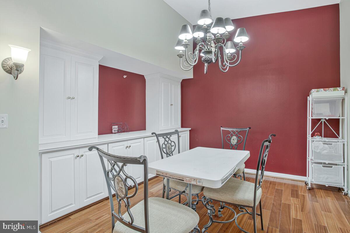 12300 Rosslare Ridge Road, Unit 508 Lutherville-Timonium, MD 21093 - Photo 15 of 40 a view of a dining room with furniture and wooden floor