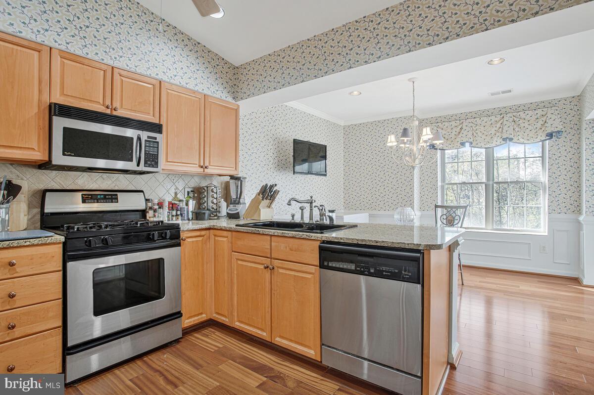 12300 Rosslare Ridge Road, Unit 508 Lutherville-Timonium, MD 21093 - Photo 17 of 40 a kitchen with stainless steel appliances granite countertop a stove microwave and sink