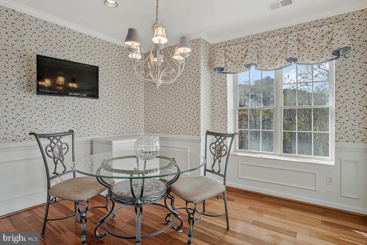 12300 Rosslare Ridge Road, Unit 508 Lutherville-Timonium, MD 21093 - Photo 21 of 40 a view of a dining room with furniture wooden floor and chandelier