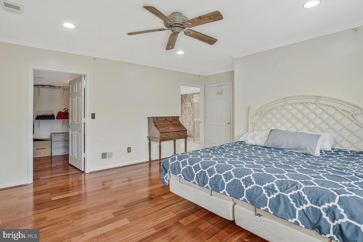 12300 Rosslare Ridge Road, Unit 508 Lutherville-Timonium, MD 21093 - Photo 26 of 40 a bedroom with a bed and a chandelier