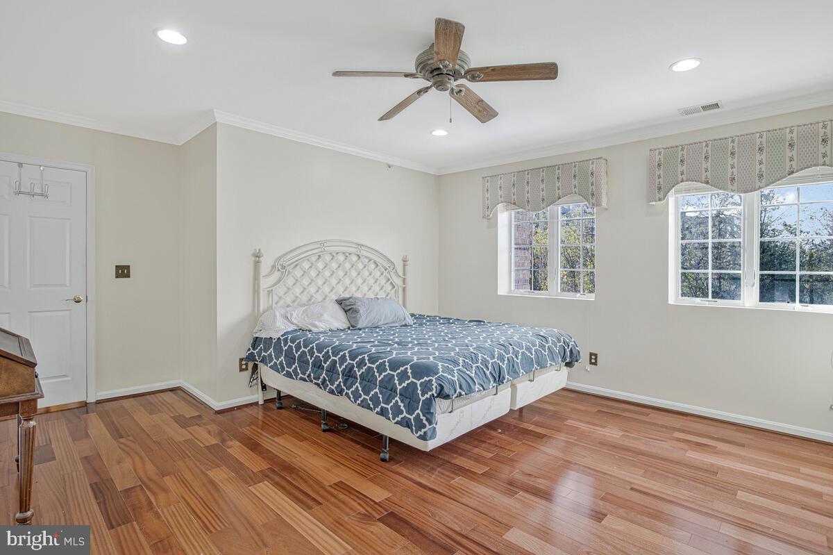 12300 Rosslare Ridge Road, Unit 508 Lutherville-Timonium, MD 21093 - Photo 27 of 40 a bedroom with a bed ceiling fan and window