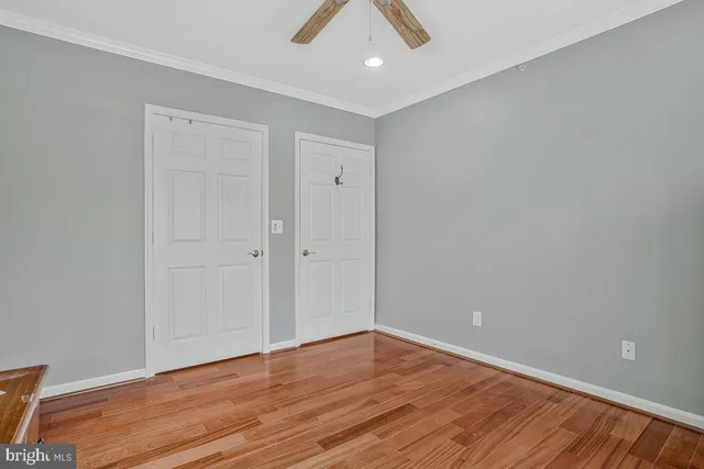 a view of an empty room with wooden floor