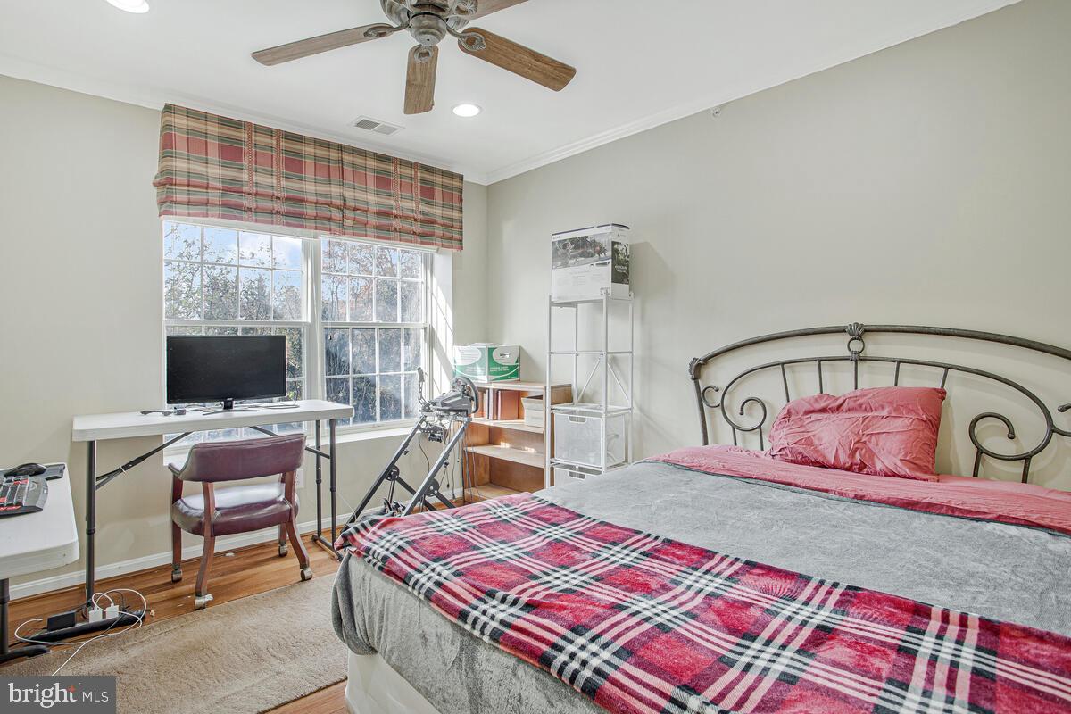 12300 Rosslare Ridge Road, Unit 508 Lutherville-Timonium, MD 21093 - Photo 33 of 40 a bedroom with a bed and a flat screen tv