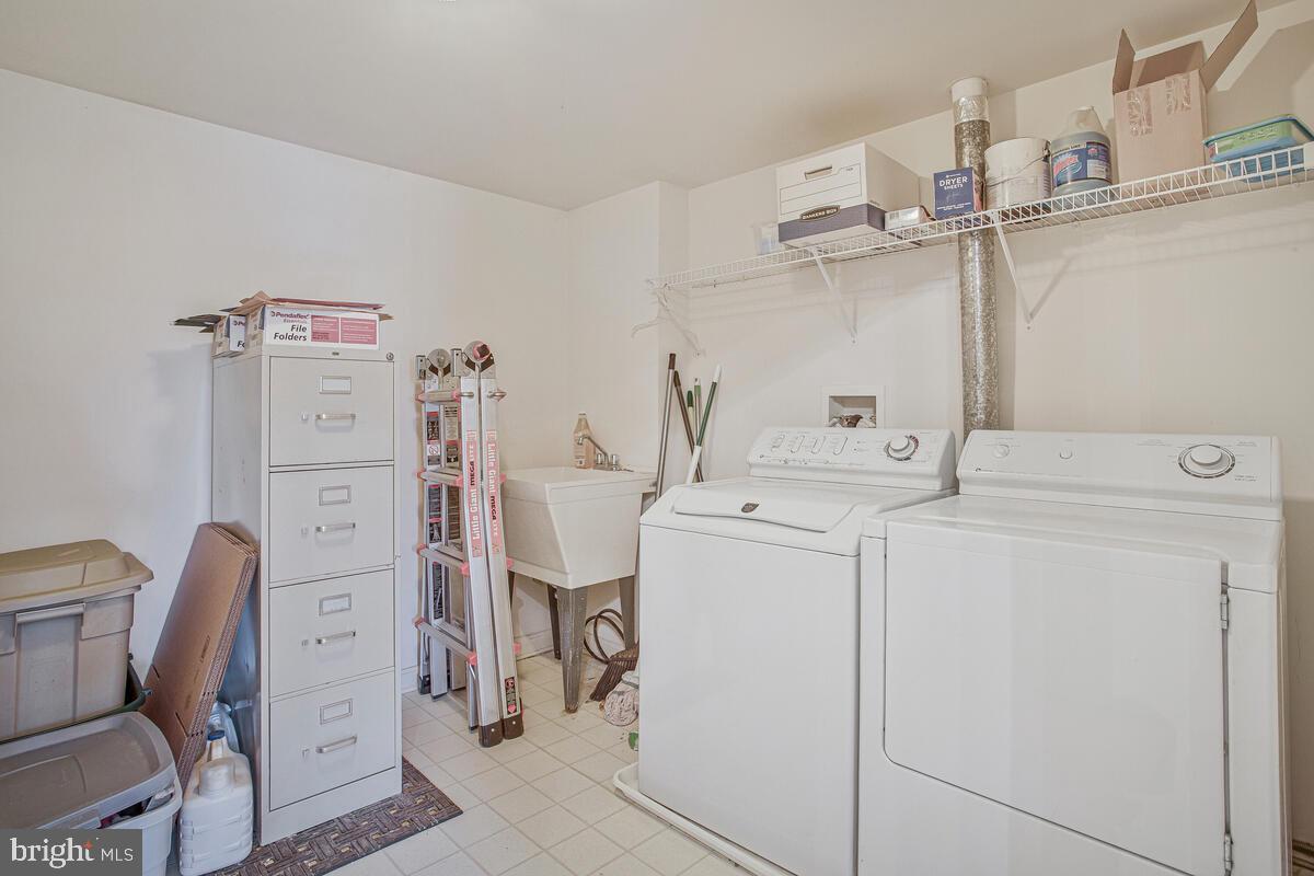 12300 Rosslare Ridge Road, Unit 508 Lutherville-Timonium, MD 21093 - Photo 39 of 40 a utility room with dryer and washer