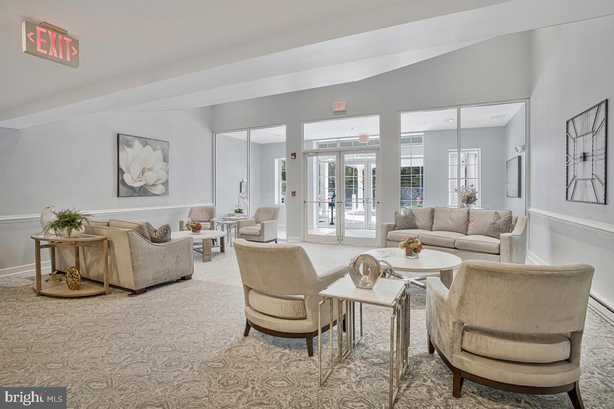 12300 Rosslare Ridge Road, Unit 508 Lutherville-Timonium, MD 21093 - Photo 7 of 40 a living room with furniture and a large mirror