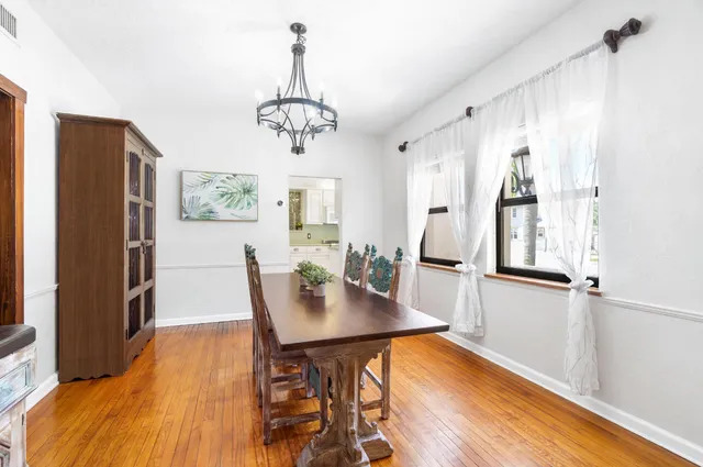 a large white kitchen with a large window