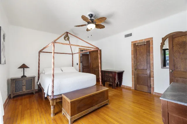 a bedroom with a bed and a chandelier