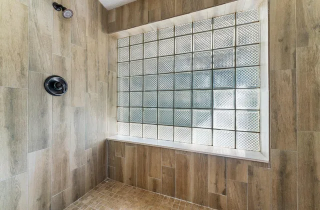 a view of a patio with a table and chairs under an umbrella