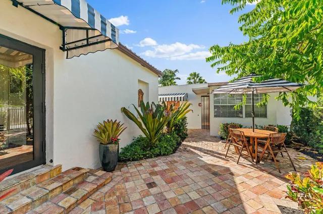a bedroom with a bed a flat screen tv and a chandelier
