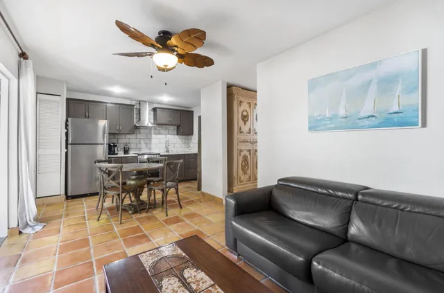 a view of a swimming pool with a patio and plants